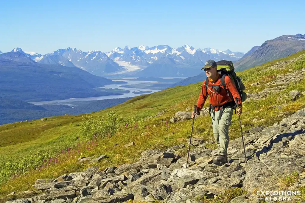 Backpacker hiking Southern Traverse backpacking trip Bremner River, Wrangell-St. Elias National Park, Alaska.