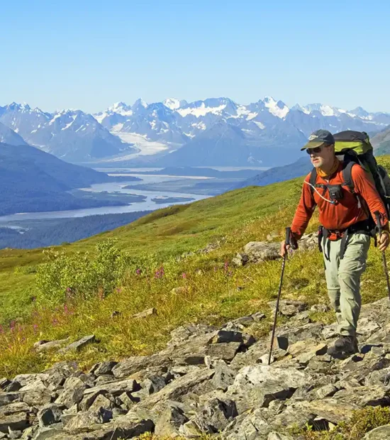 Backpacker hiking Southern Traverse backpacking trip Bremner River, Wrangell-St. Elias National Park, Alaska.