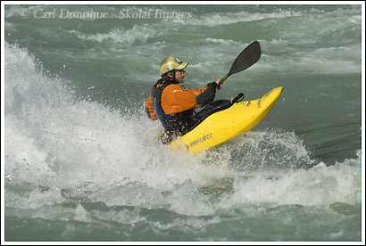 Kayaker surfing a wave on the Baker River, Patagonia, Chile.