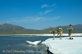 Hikers enjoying horseplay of aufeis, Canning River, Arctic National Wildlife Refuge (ANWR), Alaska.