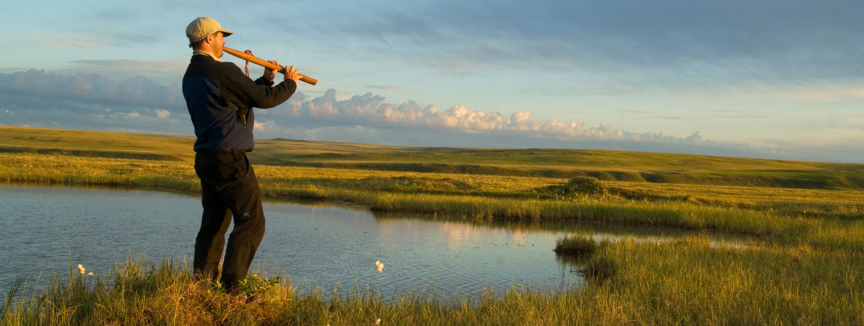 ANWR trips Hiker playing American Native flute on coastal plain Arctic National Wildlife Refuge, Alaska.