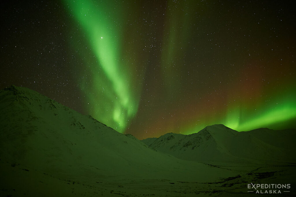 Northern lights glow over the Brooks Range, Arctic Alaska.