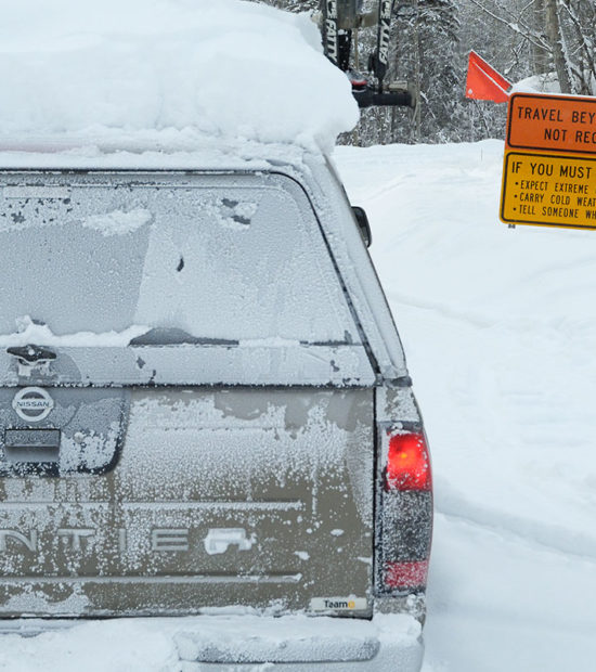 Nissan Frontier pickup truck on McCarthy Road in harsh winter conditions, Wrangell-St. Elias National Park, Alaska.