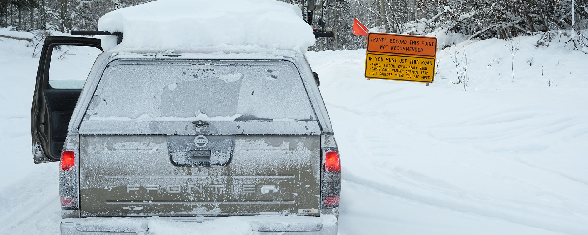 Nissan Frontier pickup truck on McCarthy Road in harsh winter conditions, Wrangell-St. Elias National Park, Alaska.