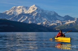 Sea kayaking in Icy Bay, with Mount St. Elias rising in the background, 18 008' high above the sea. Wrangell-St. Elias National Park and Preserve, Alaska.