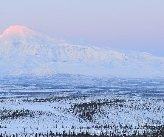 Snowshoeing trip Wrangell-St. Elias National Park Mt. Sanford dawn winter, Alaska.