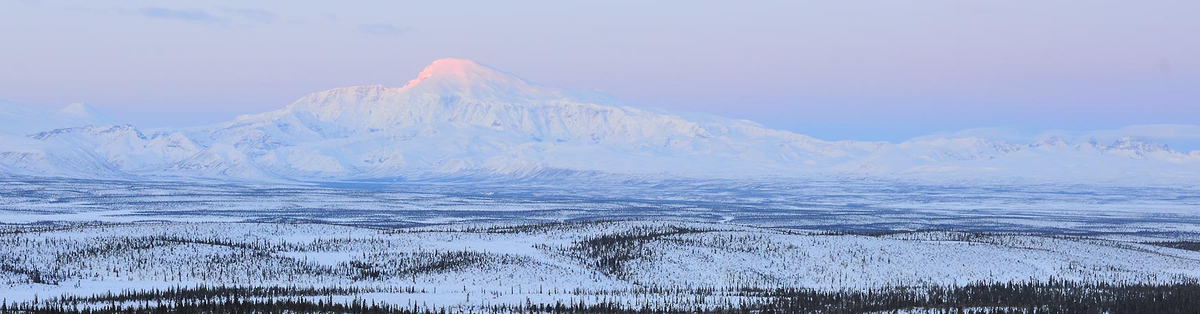 Snowshoeing trip Wrangell-St. Elias National Park Mt. Sanford dawn winter, Alaska.