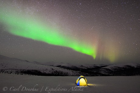 A backlit tent and the northern lights in the White Mountains, Alaska