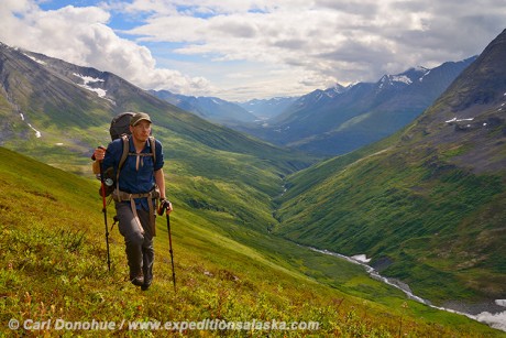 A hiker backpacking up Harry's Gulch in the eastern Chugach mountains of Wrangell-St. Elias National Park and Preserve, Alaska.