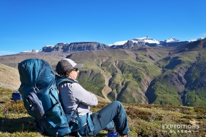 Hiker resting on Goat Trail, Wrangell St. Elias National Park, Alaska.