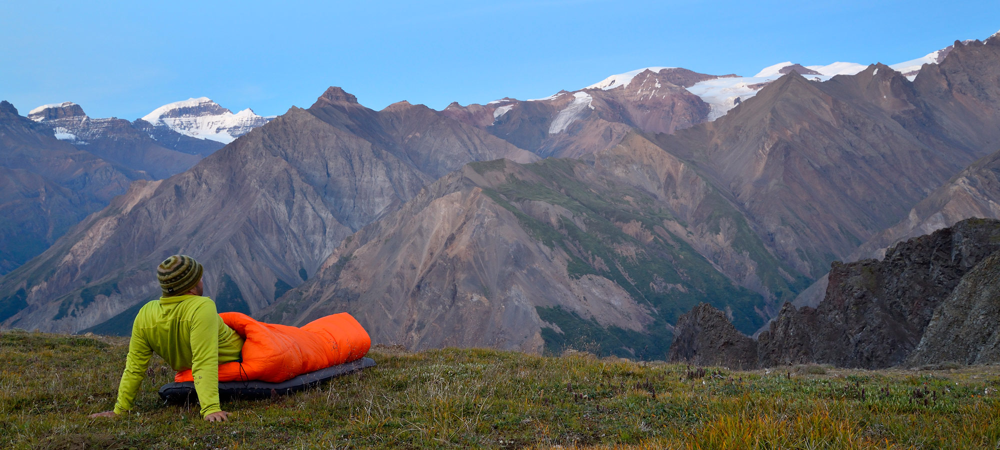 camper looking at University Range, Goat Trail trip, Wrangell - St. Elias National Park, Alaska.