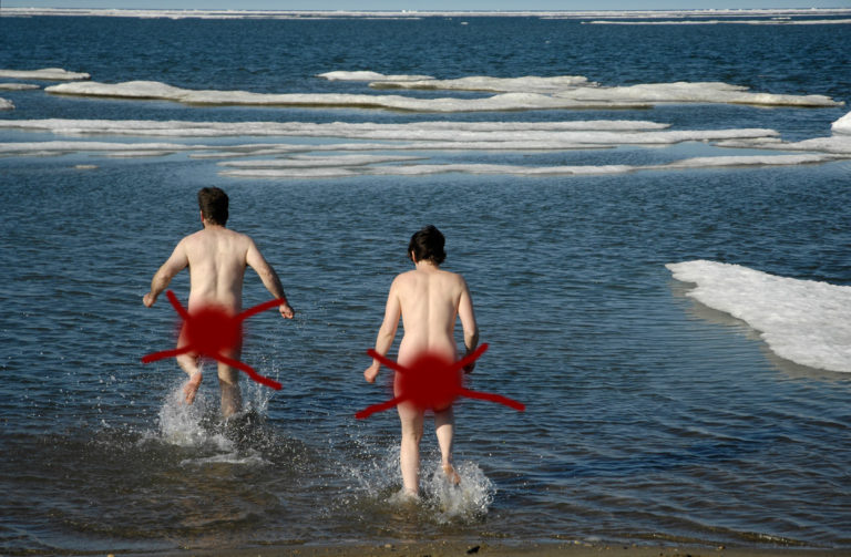 Adventurers taking a swim in the Arctic Ocean, ANWR rafting trip on Canning River, Arctic National Wildlife Refuge, Alaska.