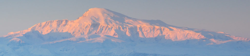 Alaska Snowshoeing trip Mt Sanford at dawn, with alpenglow, Wrangell-St. Elias National Park.