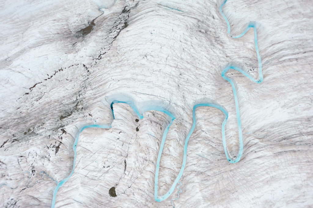 Aerial shot of a creek on a glacier.