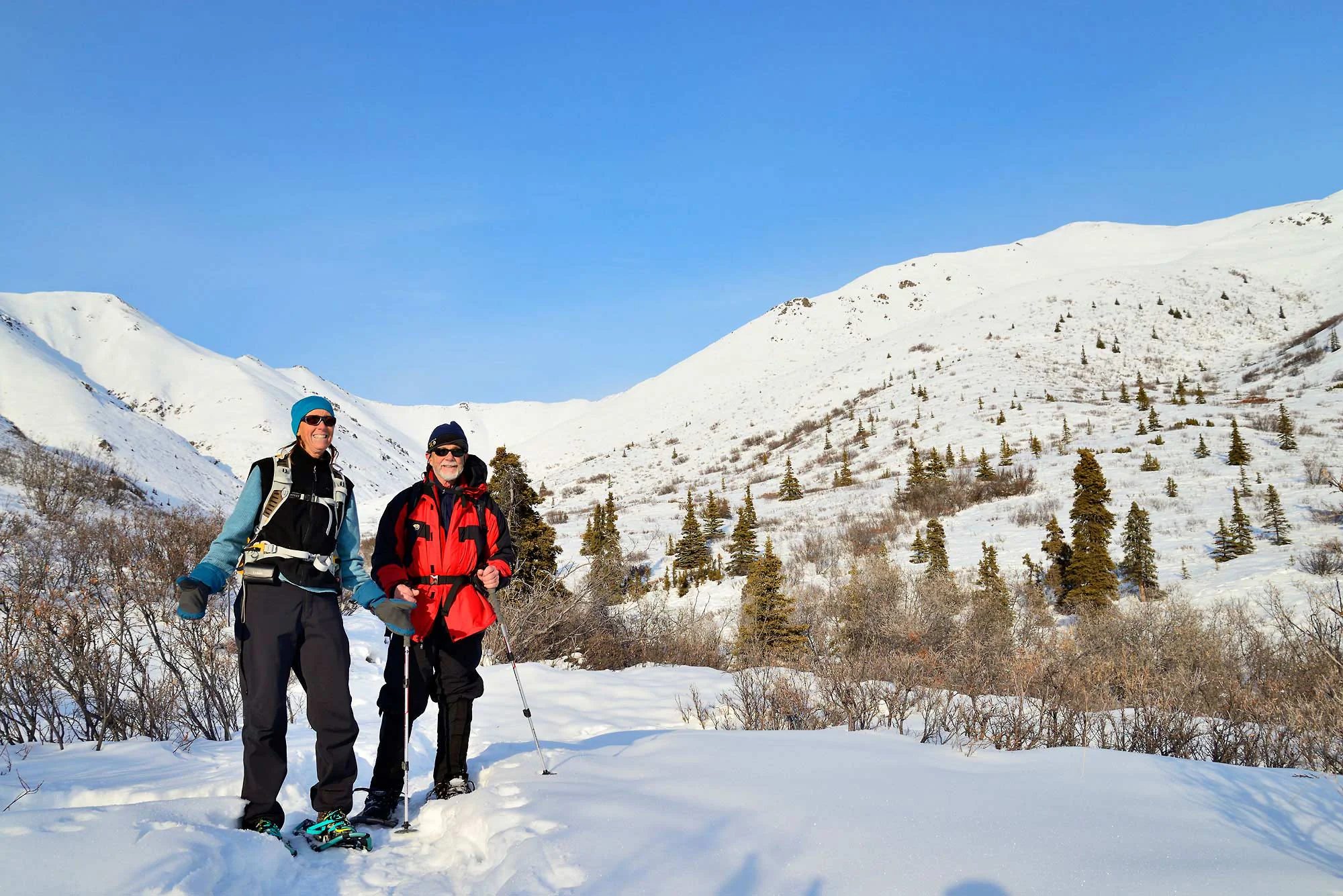 Alaska Snowshoe trips Bob and Nancy pause for a photo while snowshoeing on the Caribou Creek Trail, in Wrangell-St. Elias National Park and Preserve, Alaska