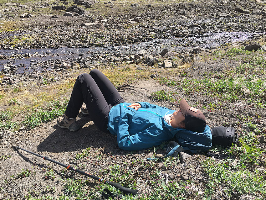Backpacker resting on Goat Trail trip, Wrangell-St. Elias National Park, Alaska.