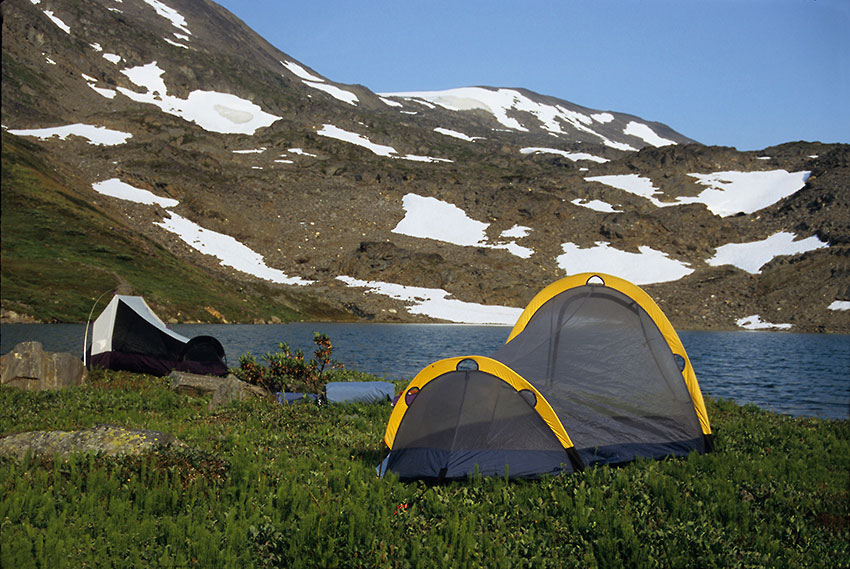 Camping by an alpine tarn, Wrangell-St. Elias National Park, Alaska.