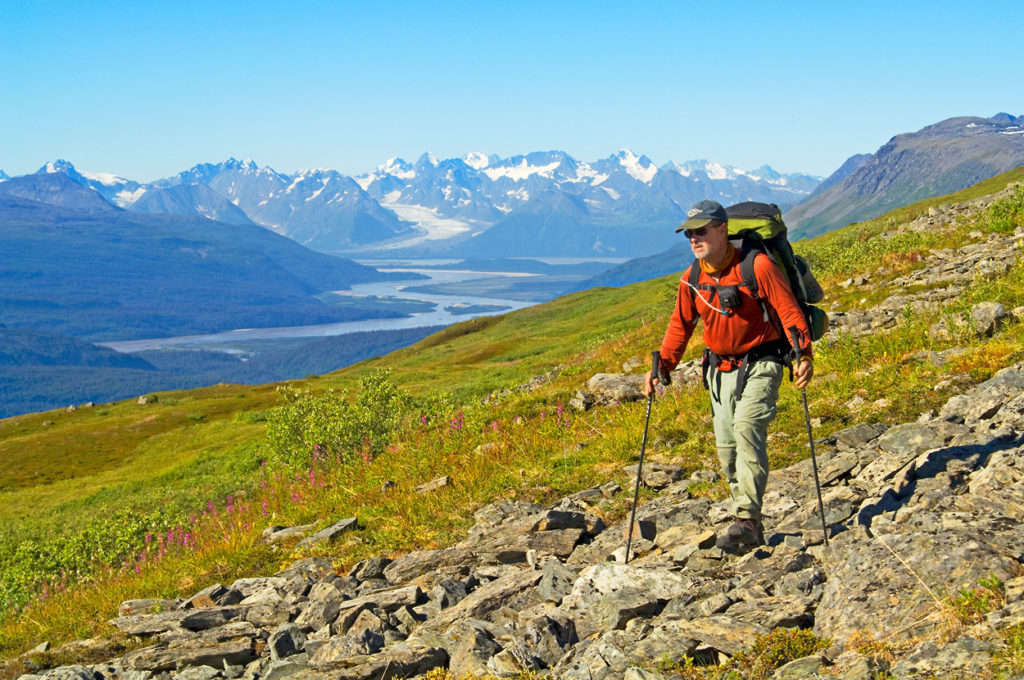 Backpacker hiking Southern Traverse backpacking trip Bremner River, Wrangell-St. Elias National Park, Alaska.