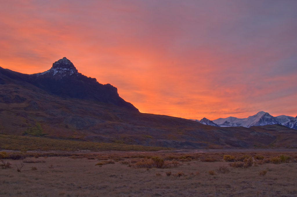 Alaska landscapes photography tours Colorful skies at dawn over Capital Peak, Skolai Pass, Wrangell-St. Elias National Park, Alaska.