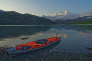 Guided Alaska Sea kayak trip parked on shore with Mt. St. Elias, Icy Bay, Wrangell-St. Elias National Park, Alaska.