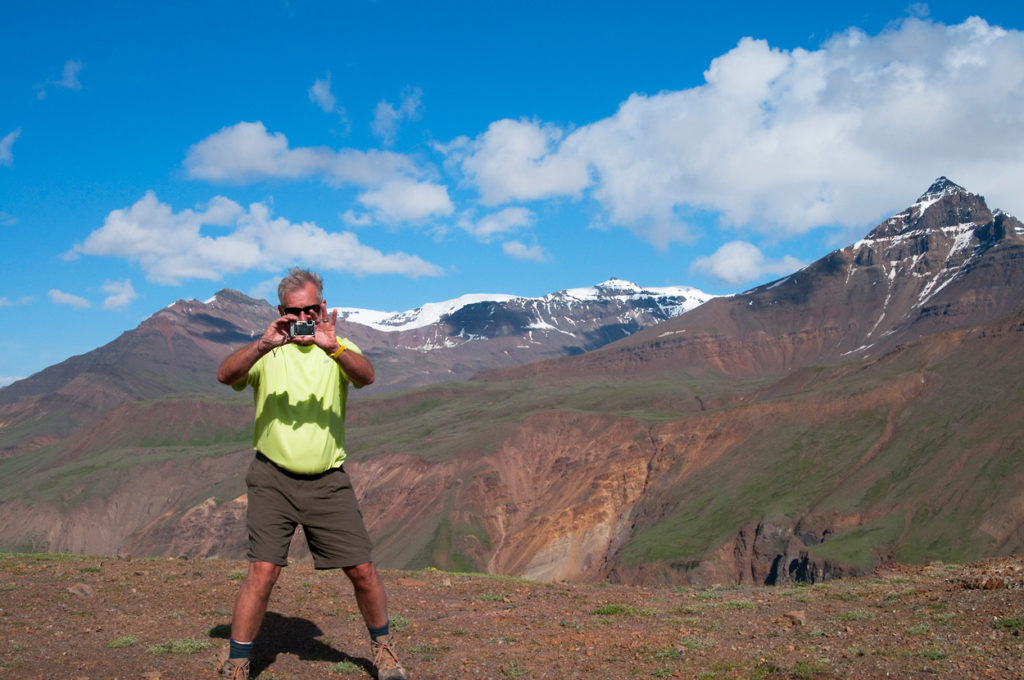 Hiker photographing the Goat Trail hiking trip Chitistone Valley, Wrangell-St. Elias National Park, Alaska.