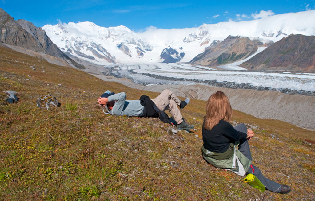 Backpackers take in the view of Mt. Blackburn and Kennicott Glacier, Wrangell-St. Elias National Park, Alaska.