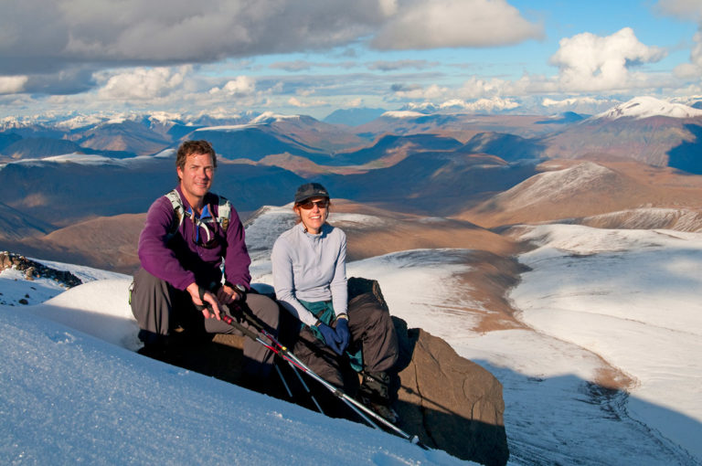 Backpackers take a break on Jarvis Plateau hiking trip in Wrangell-St. Elias National Park, Alaska.