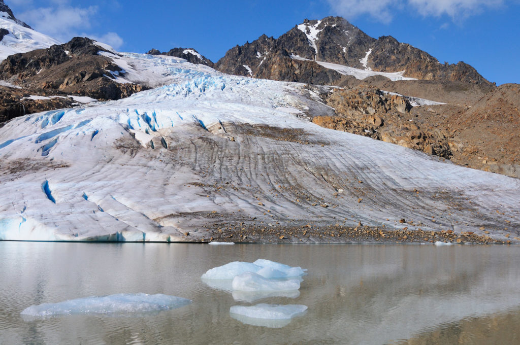 Glacier feeding a small lake near Iceberg Lake, Seven pass hiking trip, Wrangell-St. Elias National Park, Alaska.