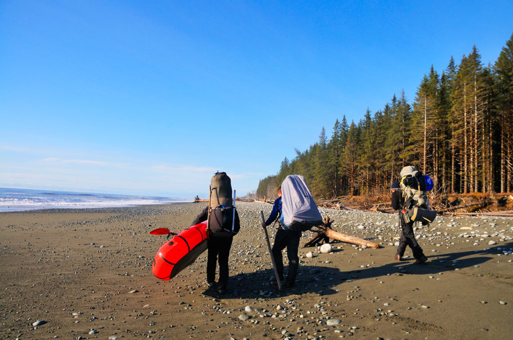 Hiking with packrafts on lost Coast backpacking trip, Wrangell-St. Elias National Park, Alaska.