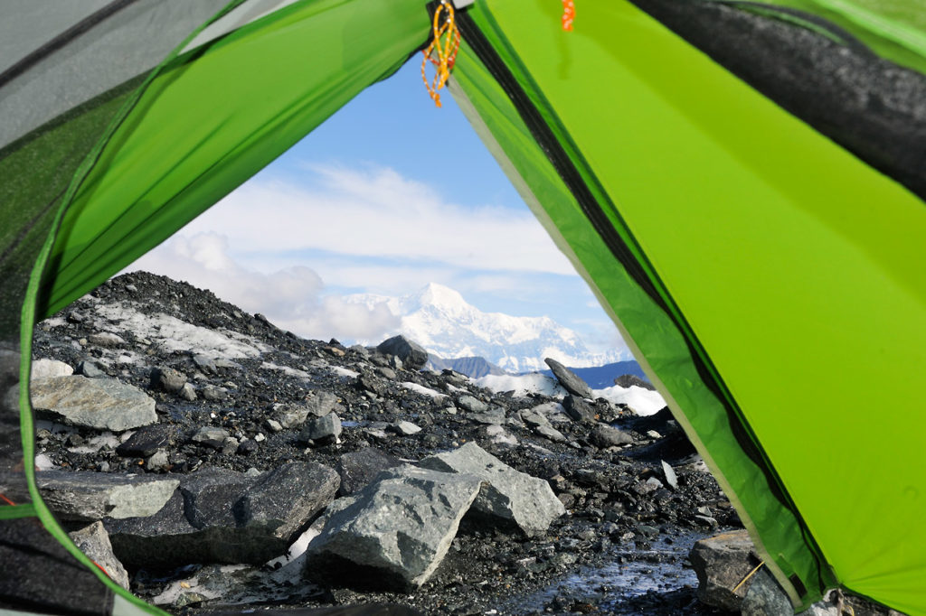 View out the door of backpacking tent on Malaspina Glacier backpacking trip in Wrangell-St. Elias National Park, Alaska.