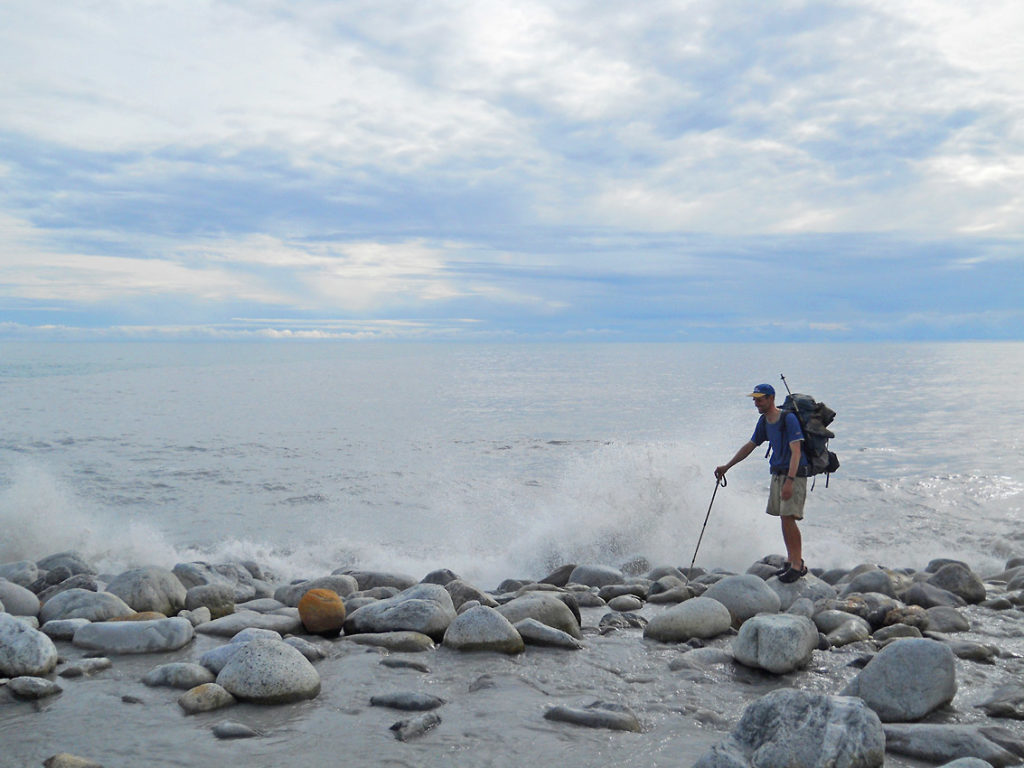 Malaspina Glacier hiking trip The Lost Coast hiking trip stream crossing Wrangell-St. Elias National Park, Alaska.