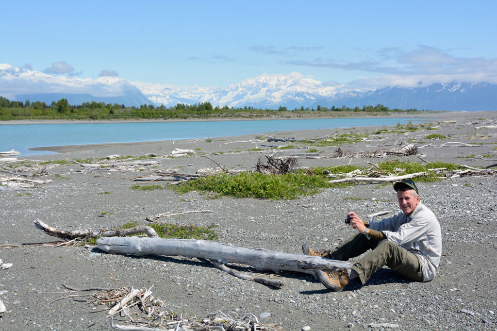 Hiker takes a break on the Lost Coast backpacking trip, Wrangell-St. Elias National Park, Alaska.