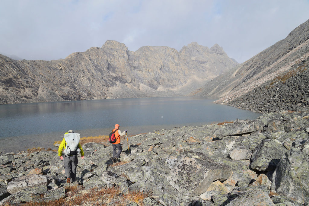 Guided backpacking trips Arrigetch Peaks Brad and Glen make their way over the boulders in Aquarius. Arrigetch Peaks backpacking trips, Gates of the Arctic National Park, Alaska.