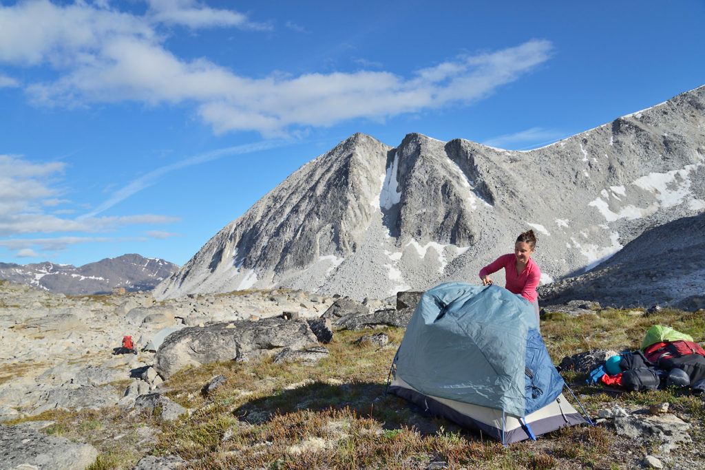 Hiker setting up camp on Seven Pass Backpacking route in Wrangell-St. Elias National Park, Alaska.