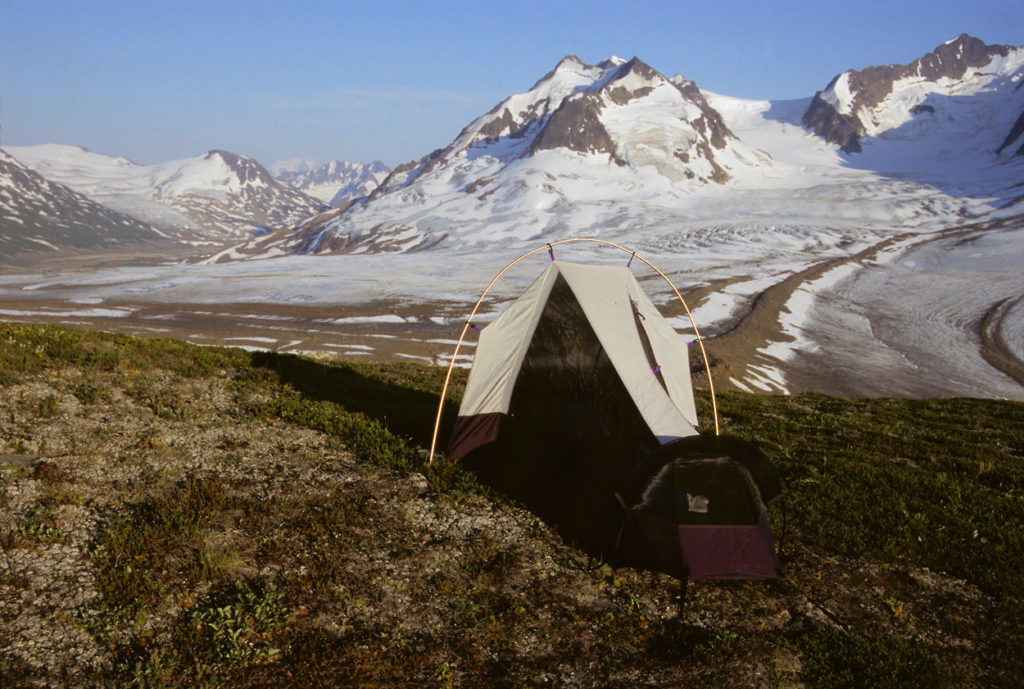 High campsite overlooking glacier on Seven Pass Route backpacking trip in Wrangell - St. Elias National Park, Alaska.
