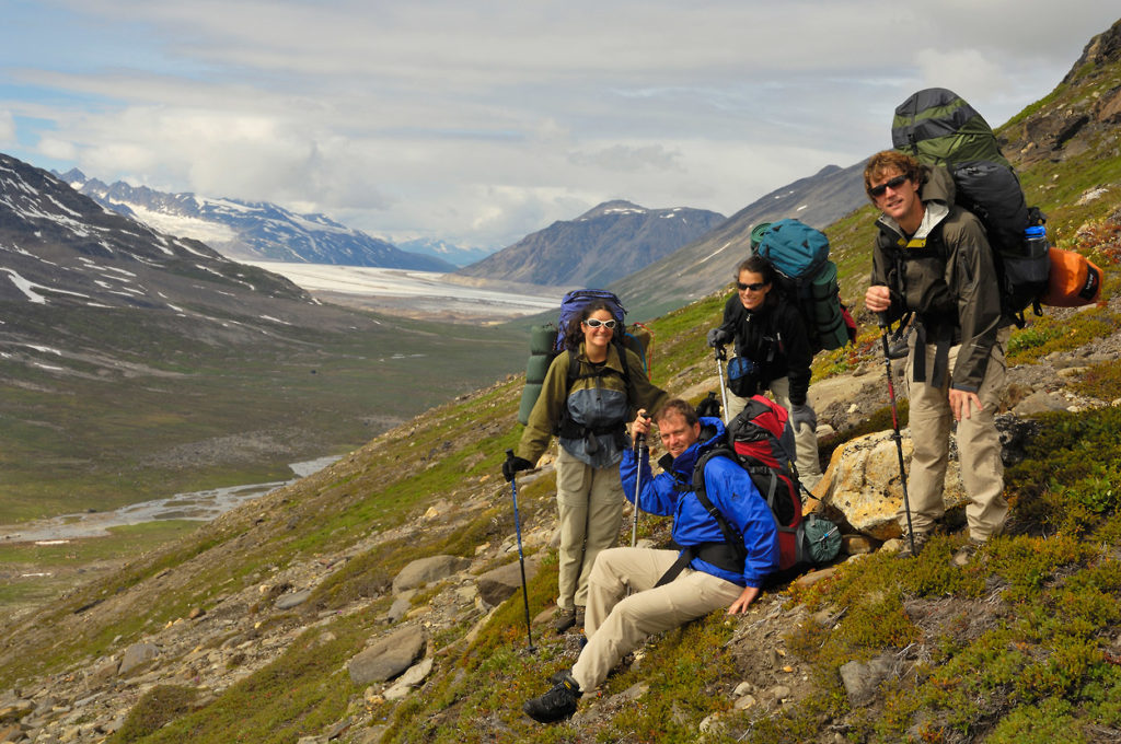 backpacking group of hikers on Seven pass Route hiking trip Wrangell-St. Elias National Park Alaska.