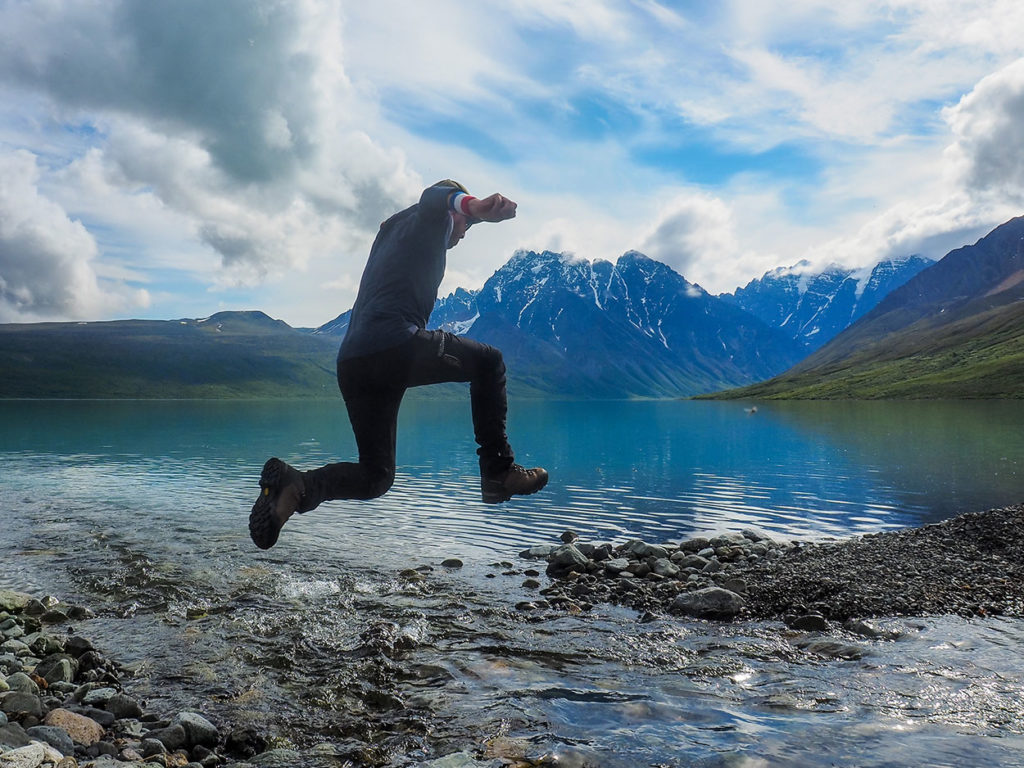 Stream crossing hiking in Lake Clark National Park Alaska.