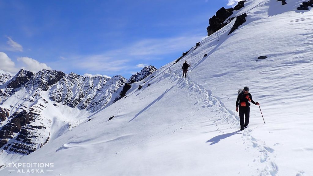 Backpackers making a snowy traverse through the Brooks range, Gates of the Arctic National Park, Alaska.