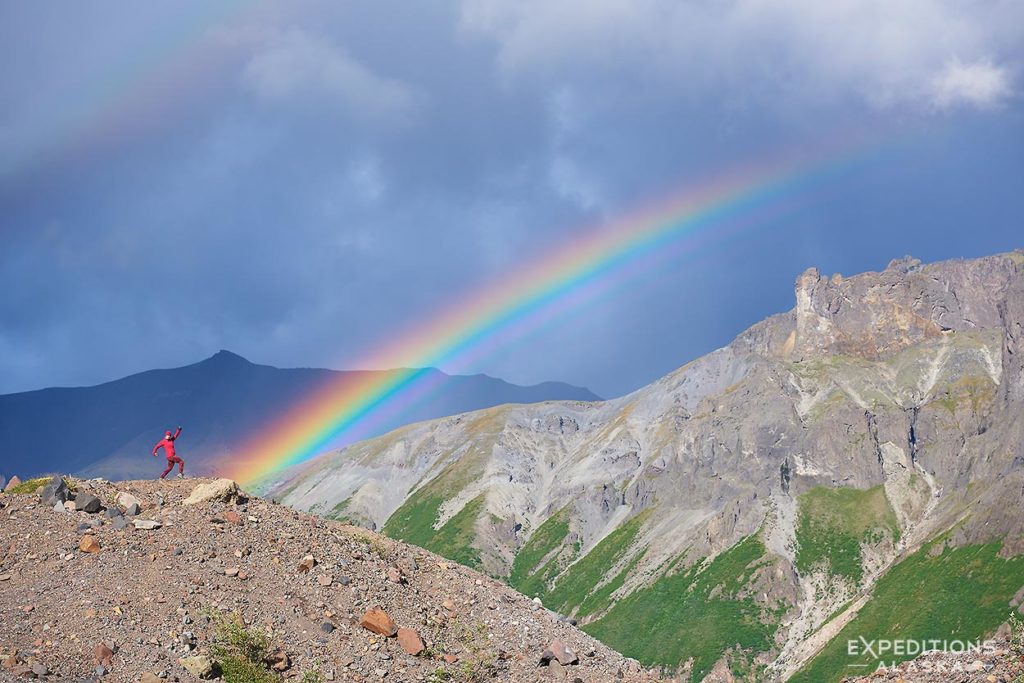 Backpacker and a rainbow, Wrangell-St. Elias National Park backpacking trip, Alaska.