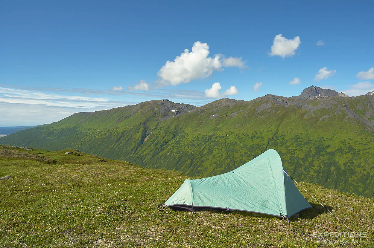 Backpacking tent on a hiking trip in Sidehilling on a backpacking trip in Denali National Park Alaska.