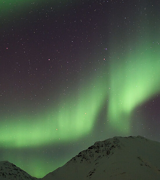 Aurora borealis night sky Brooks Range mountains Alaska.