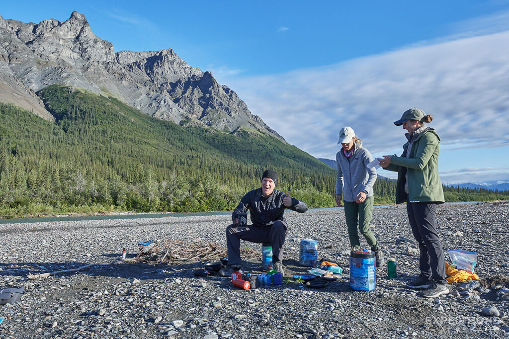 Packrafters cooking dinner on Koyukuk River, Gates of the Arctic National Park.