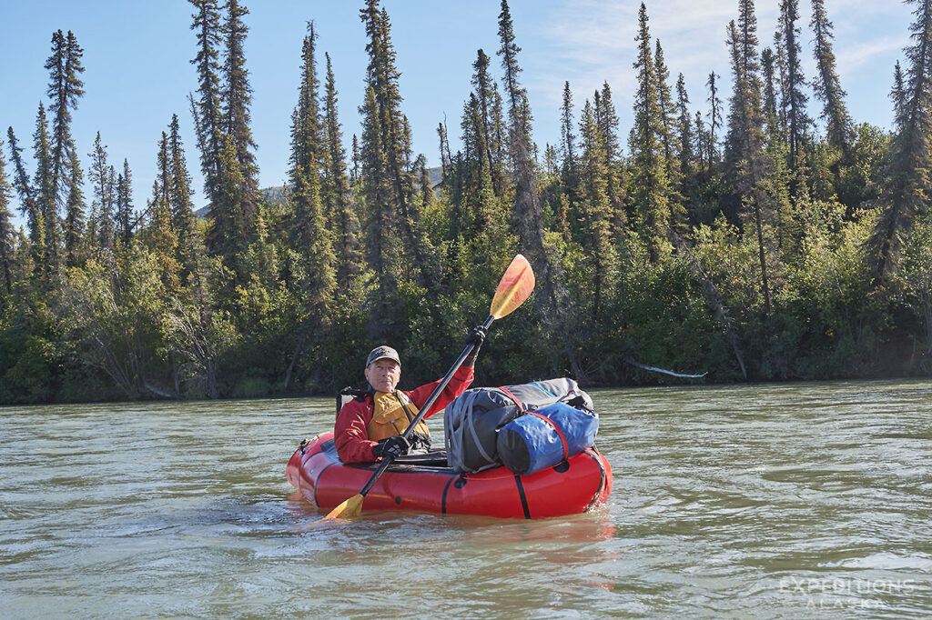 A single paddler in a packraft on Koyukuk River, Gates of the Arctic National Park.